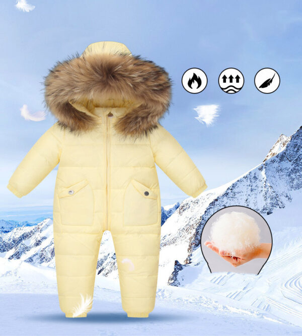 The Baby Wears White Eiderdown Over A Onesie And Down Jacket