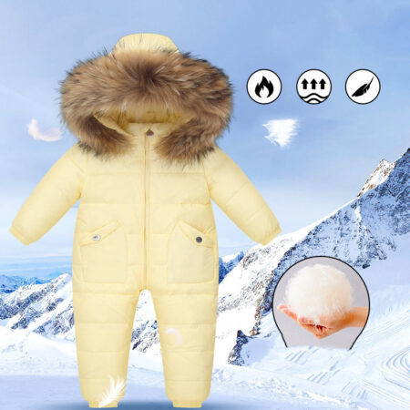 The Baby Wears White Eiderdown Over A Onesie And Down Jacket